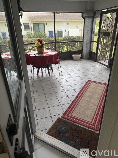 A patio with a table and chairs is visible through a glass door.