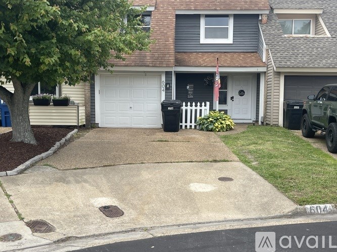 A house with a white garage door and a flag on it.