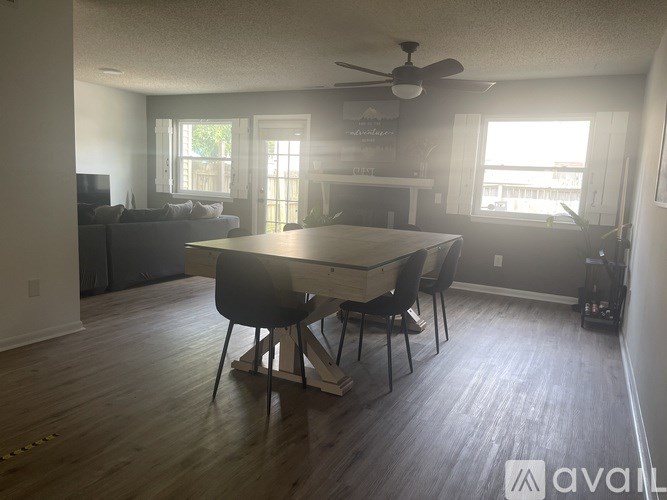 A dining room with a table and chairs.