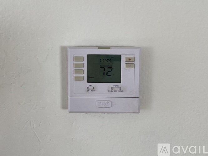 A white thermostat with a digital display showing 72 degrees.
