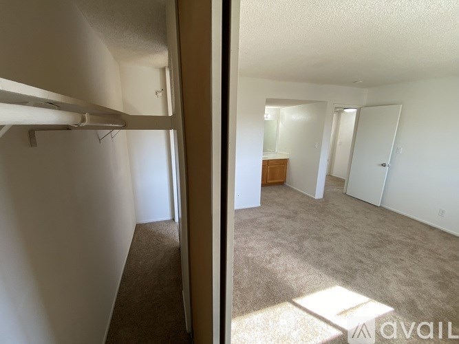 A room with a carpeted floor and white walls.