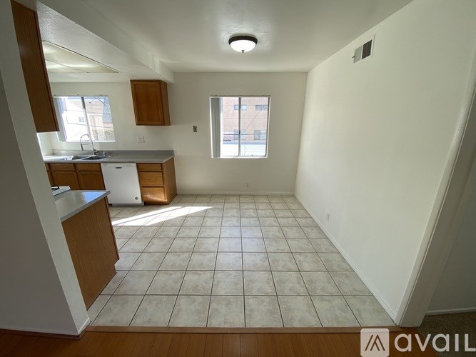 A kitchen with white appliances and wooden cabinets.