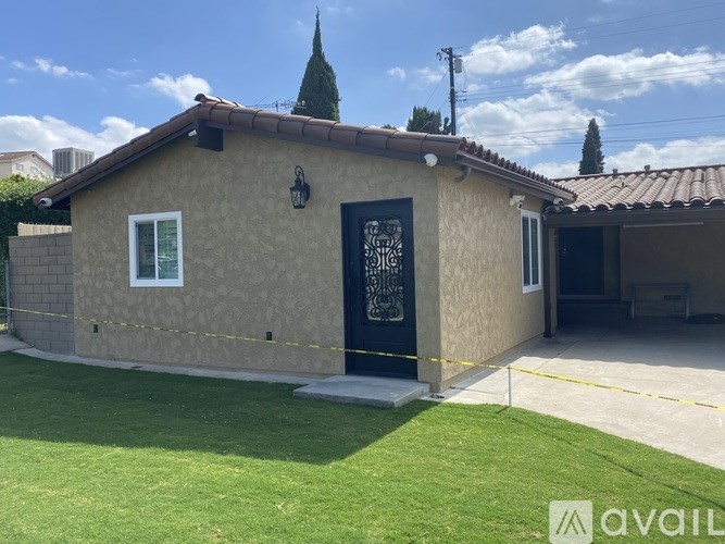 A house with a black door and a window is for sale.