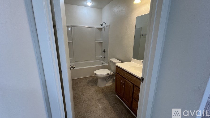 A bathroom with a toilet, sink, and shower.