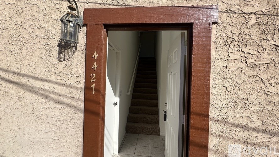 A doorway with a number 427 painted on the wall above it.