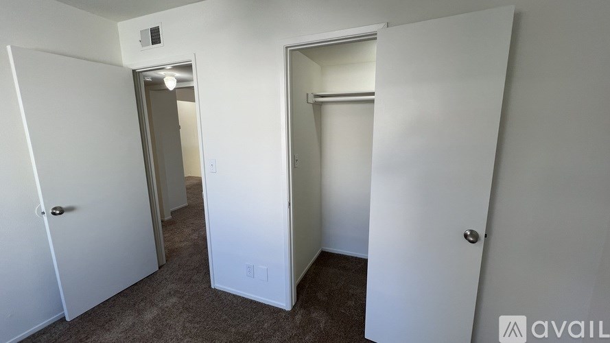 A room with two doors and a carpeted floor.