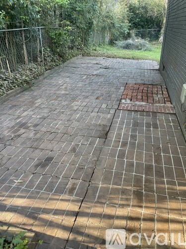 A brick pathway leads through a green area.
