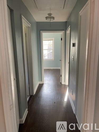 A long hallway with a light at the end.