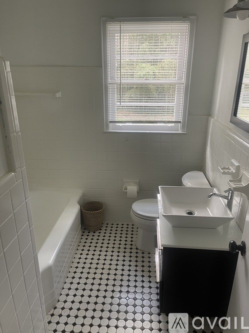 A bathroom with a black and white floor.
