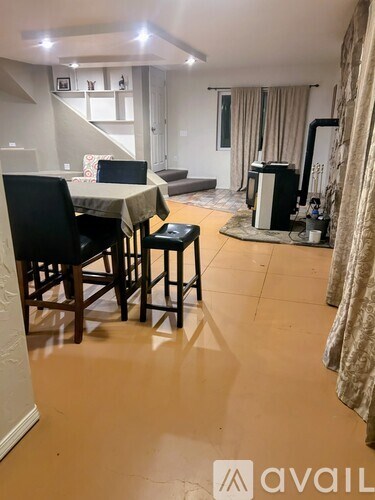 A living room with a dining table and chairs.