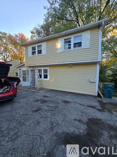 A house with a car parked in front of it.
