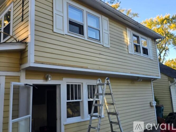 A house with a ladder on the porch.
