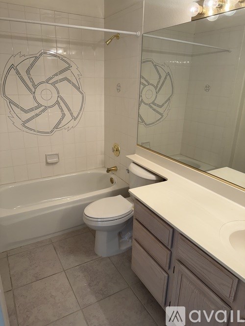 A bathroom with a white toilet and a bathtub with a glass shower door.