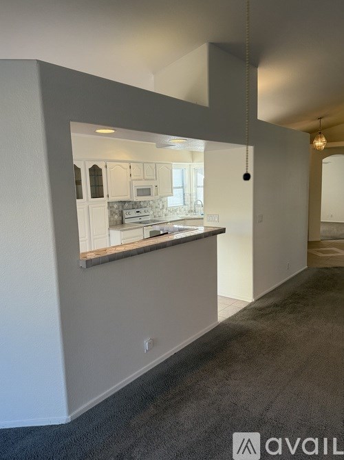A kitchen area with a countertop and cabinets.