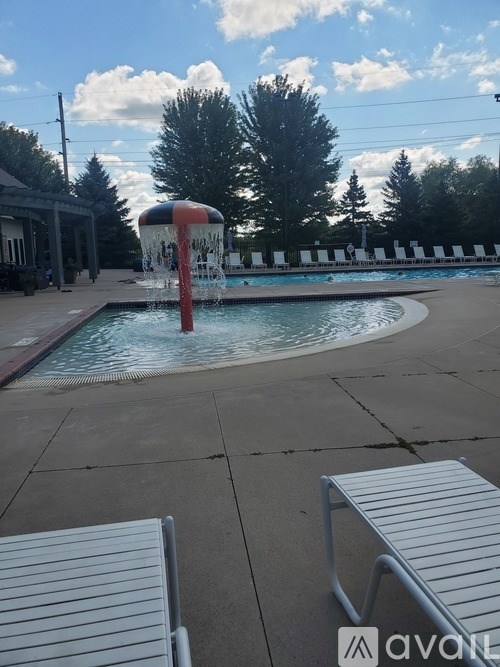 A pool with a waterfall feature in the middle of it.