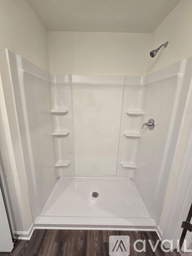 A white bathroom with a walk in shower.