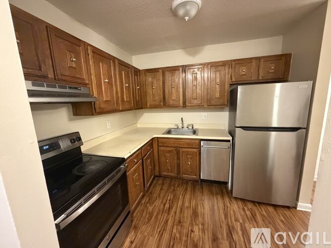 A kitchen with wooden cabinets and stainless steel appliances.
