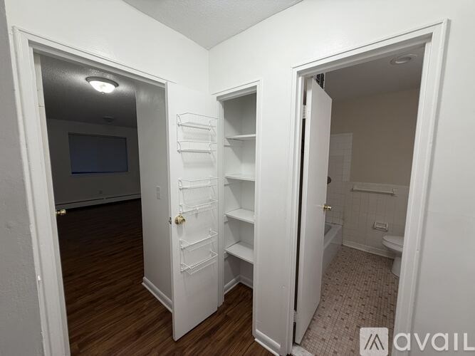 A white door is open to a bathroom.