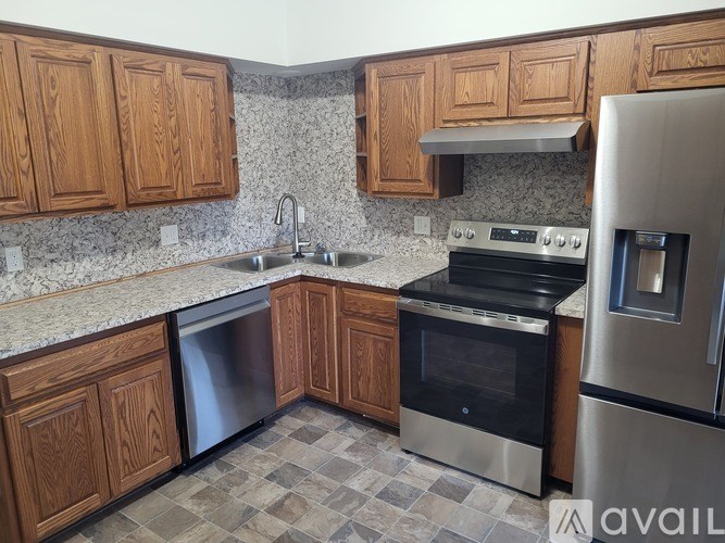A kitchen with wooden cabinets and a black oven.