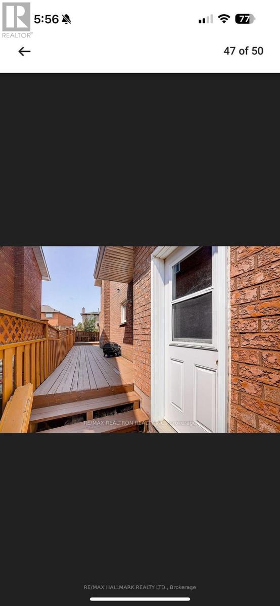 A white door is on the right side of a brick building.
