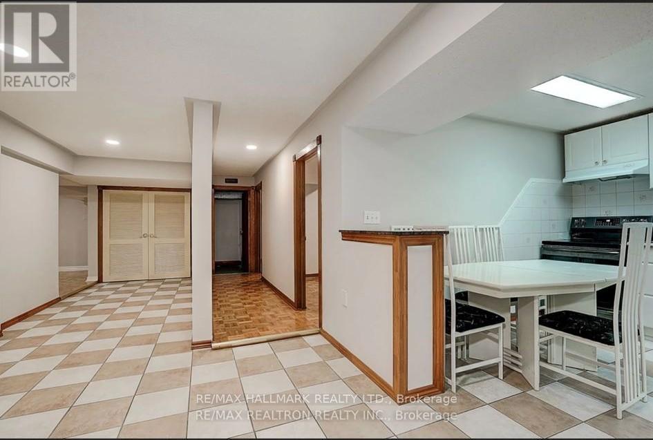 A kitchen area with a table and chairs is visible.