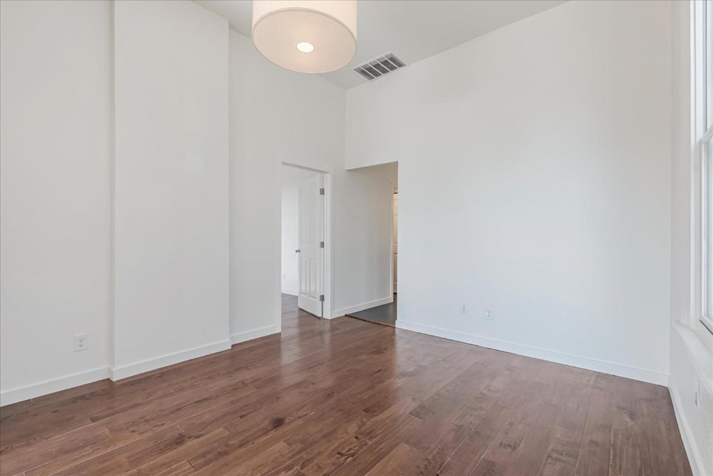 A room with wooden floors and white walls.