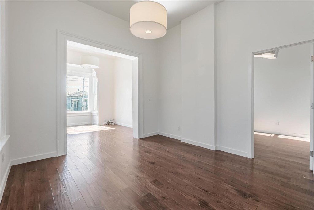 A room with wooden floors and white walls.