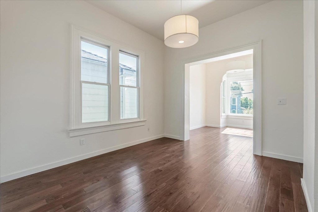 A room with wooden floors and white walls.