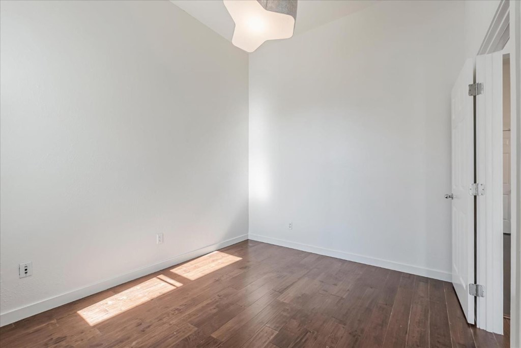 A room with wooden floors and white walls.