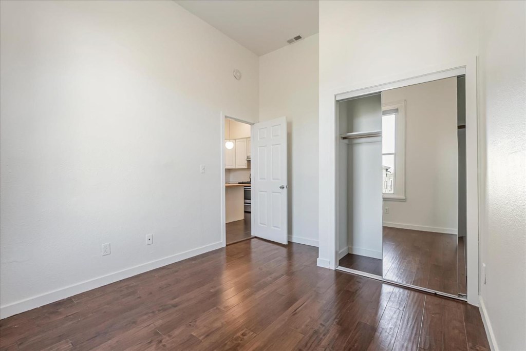 A room with wooden floors and white walls.