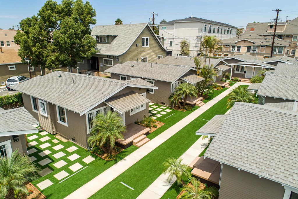 A residential area with houses and a green lawn.