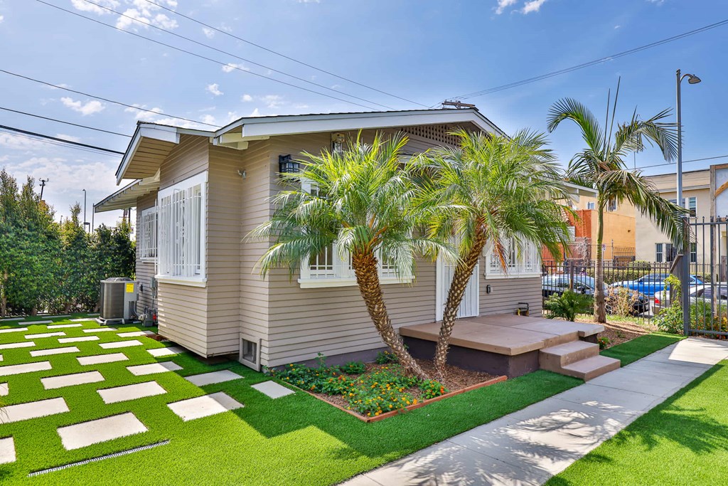 A house with a palm tree in front.
