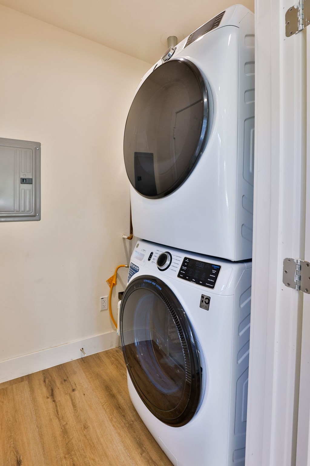 A white front load washing machine in a room.