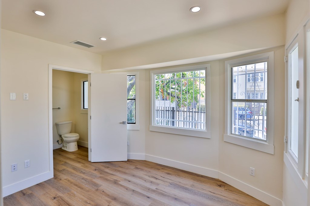 A room with a toilet and a window.