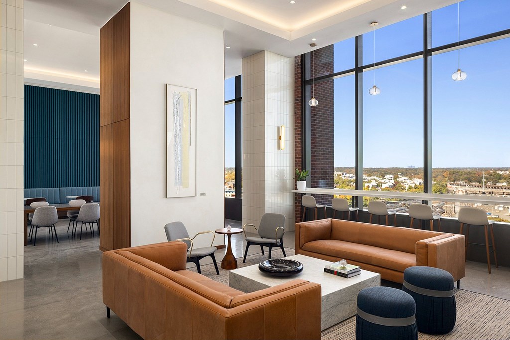 A modern living room with a large window overlooking the city.