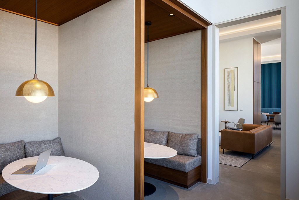 A modern living room with a white table and a grey couch.