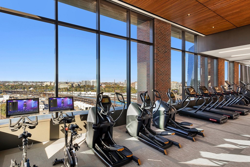 A gym with treadmills and exercise bikes is shown.