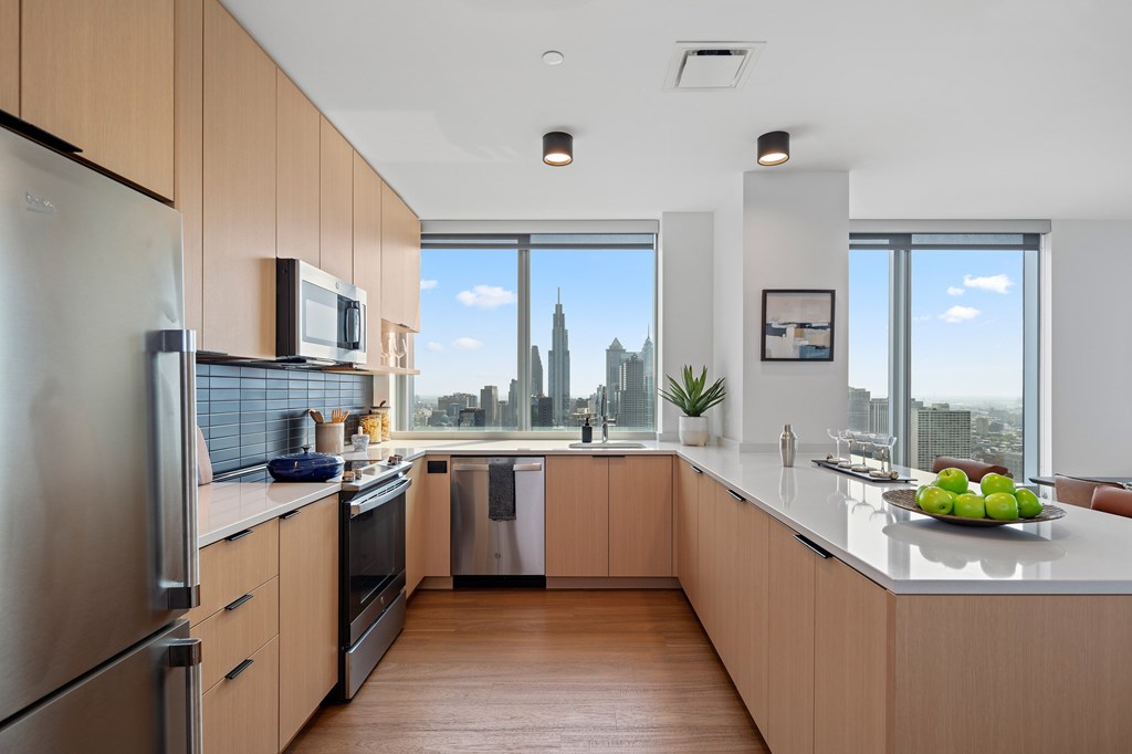 A modern kitchen with wooden cabinets and stainless steel appliances.