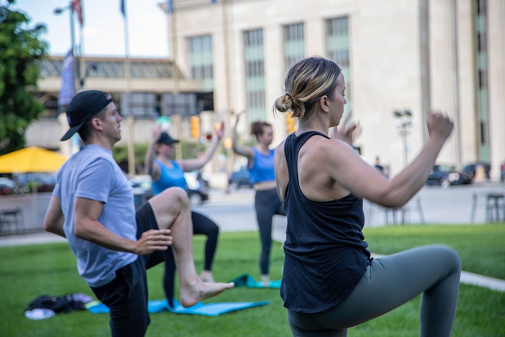 A group of people are exercising in a park.