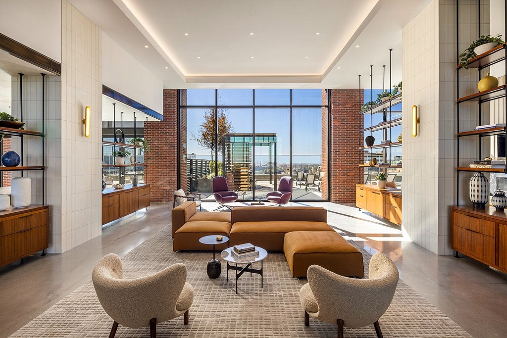 A modern living room with a large window and a view of the city.