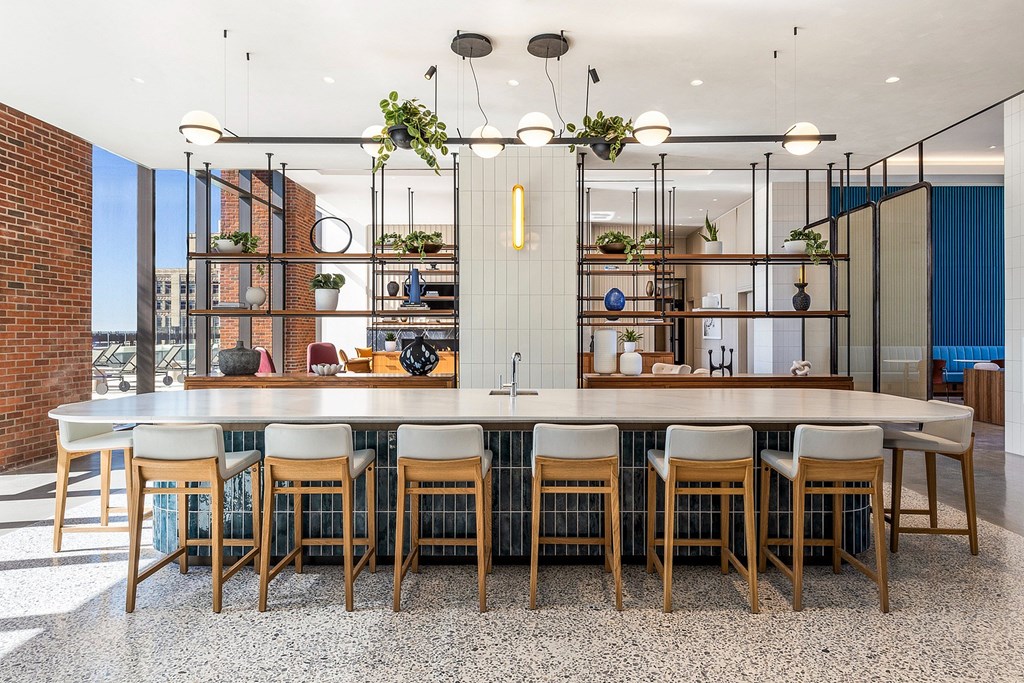 A modern dining room with a large table and chairs.