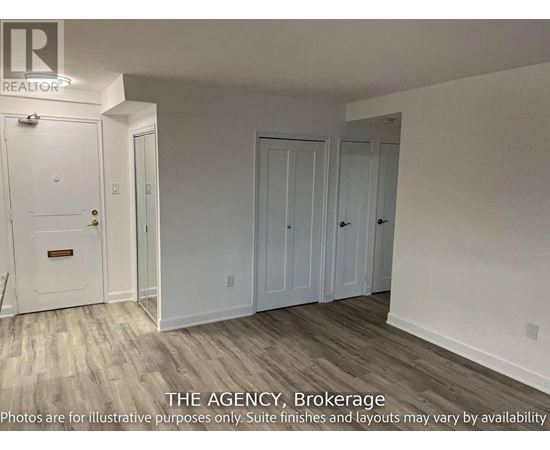 A white door with a brass handle is in a room with white walls and wood flooring.