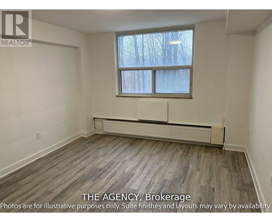 A room with a window and a radiator on the floor.