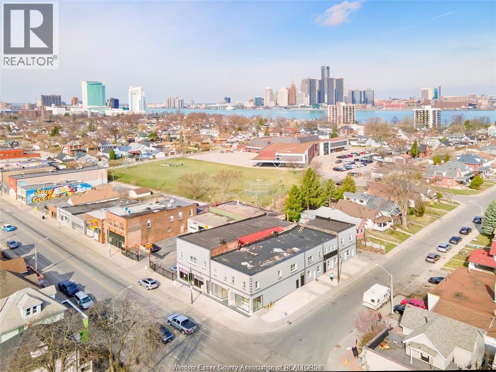 A bird's eye view of a city street with buildings and cars.