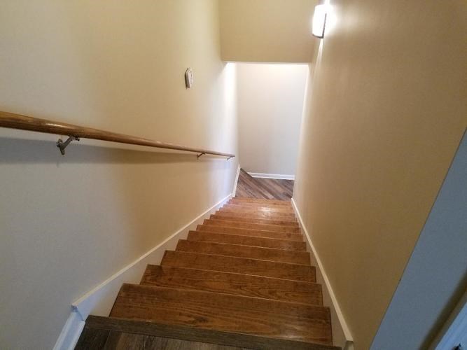 A staircase with wooden steps and a handrail.