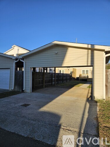 A two-story house with a garage and driveway.