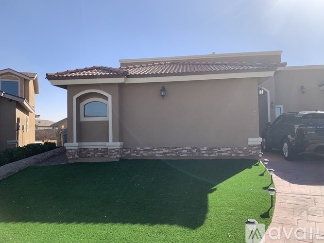 A house with a green lawn in front.