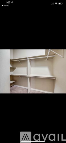 Empty white shelves in a room.