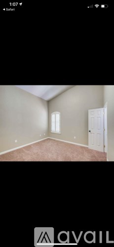A room with a carpeted floor and a door.