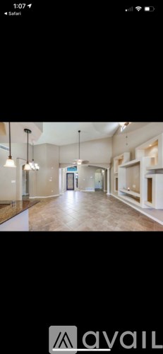 A room with wooden floors and a white ceiling with hanging lights.